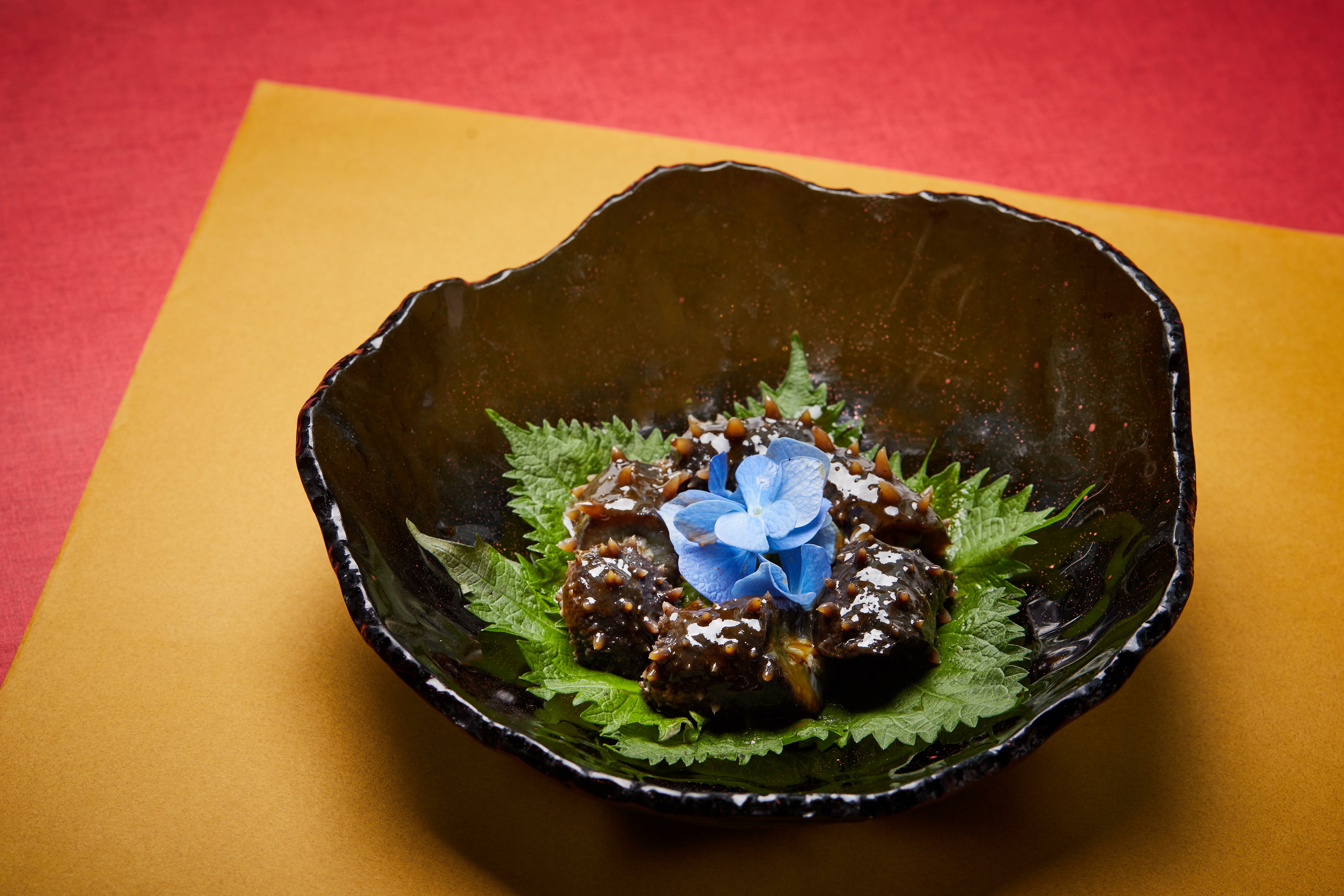 A bowl of food with a flower Description automatically generated