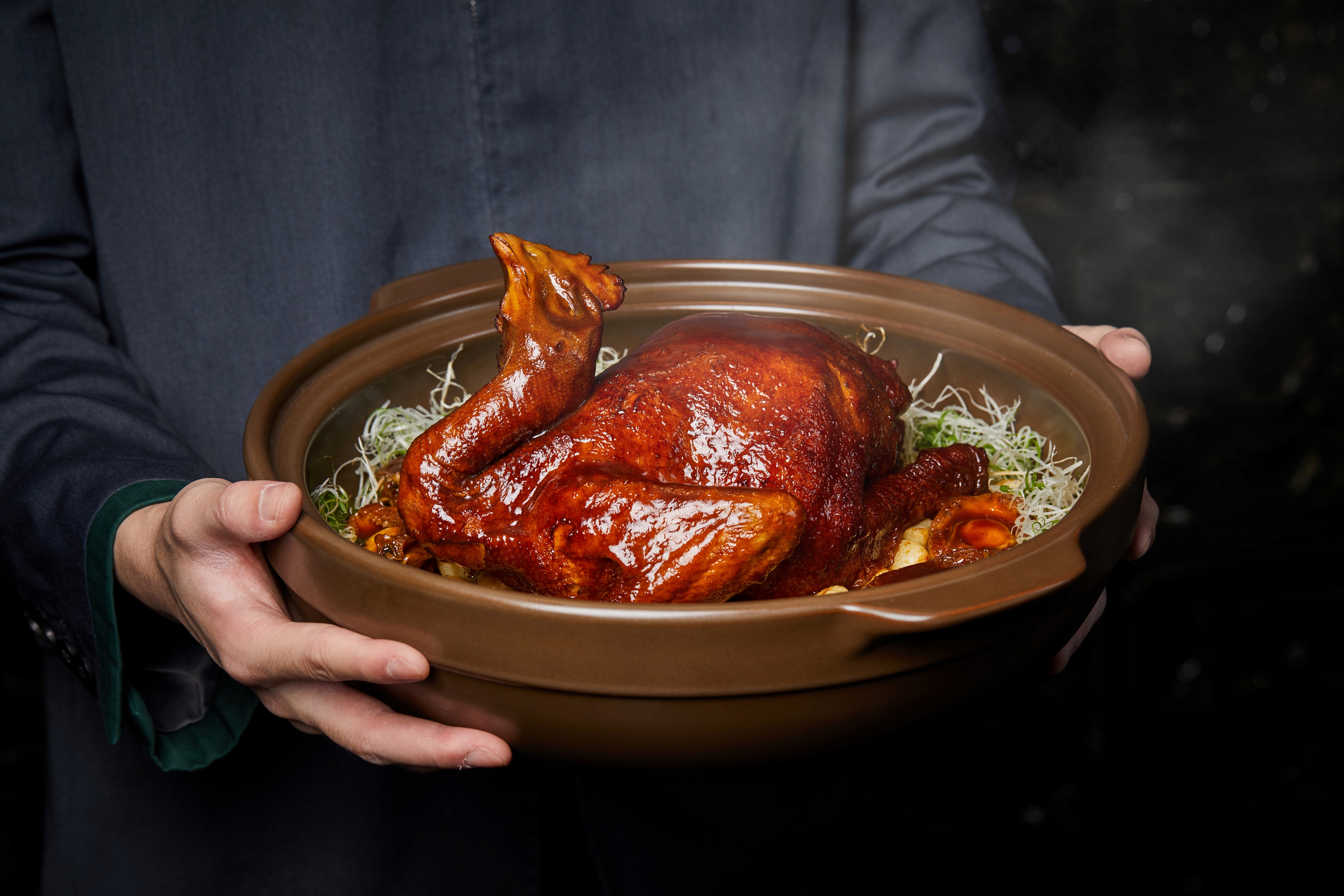 A person holding a bowl of food Description automatically generated